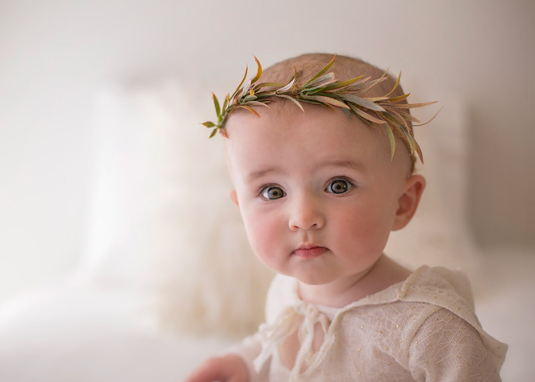 Baby looking in camera with Christmas headband